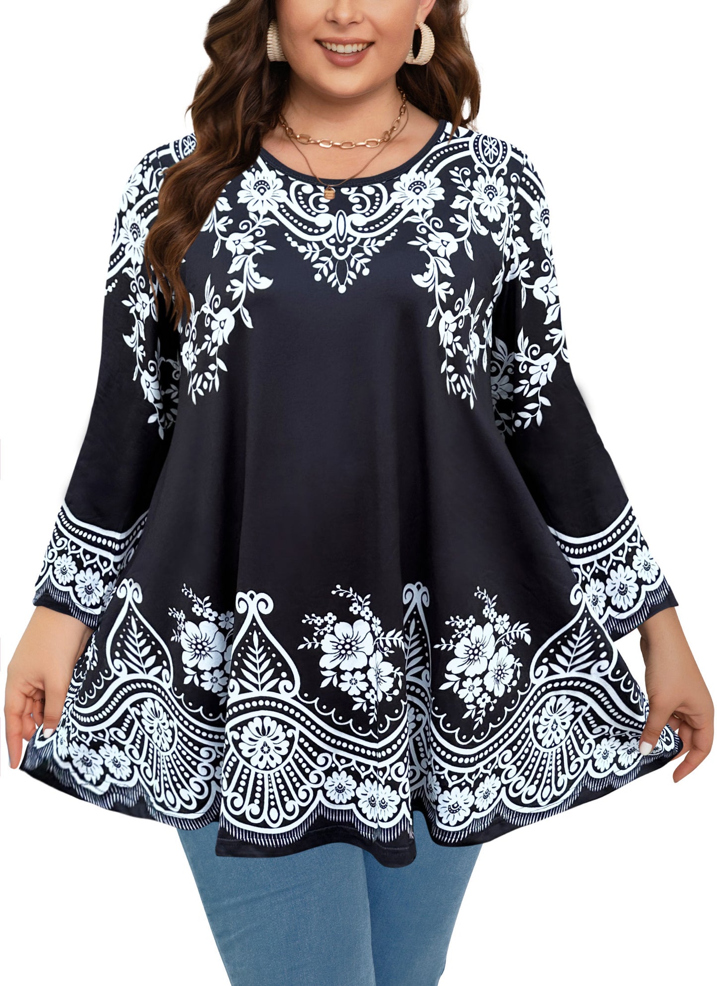 Woman wearing a black top with white floral embroidery on a white background