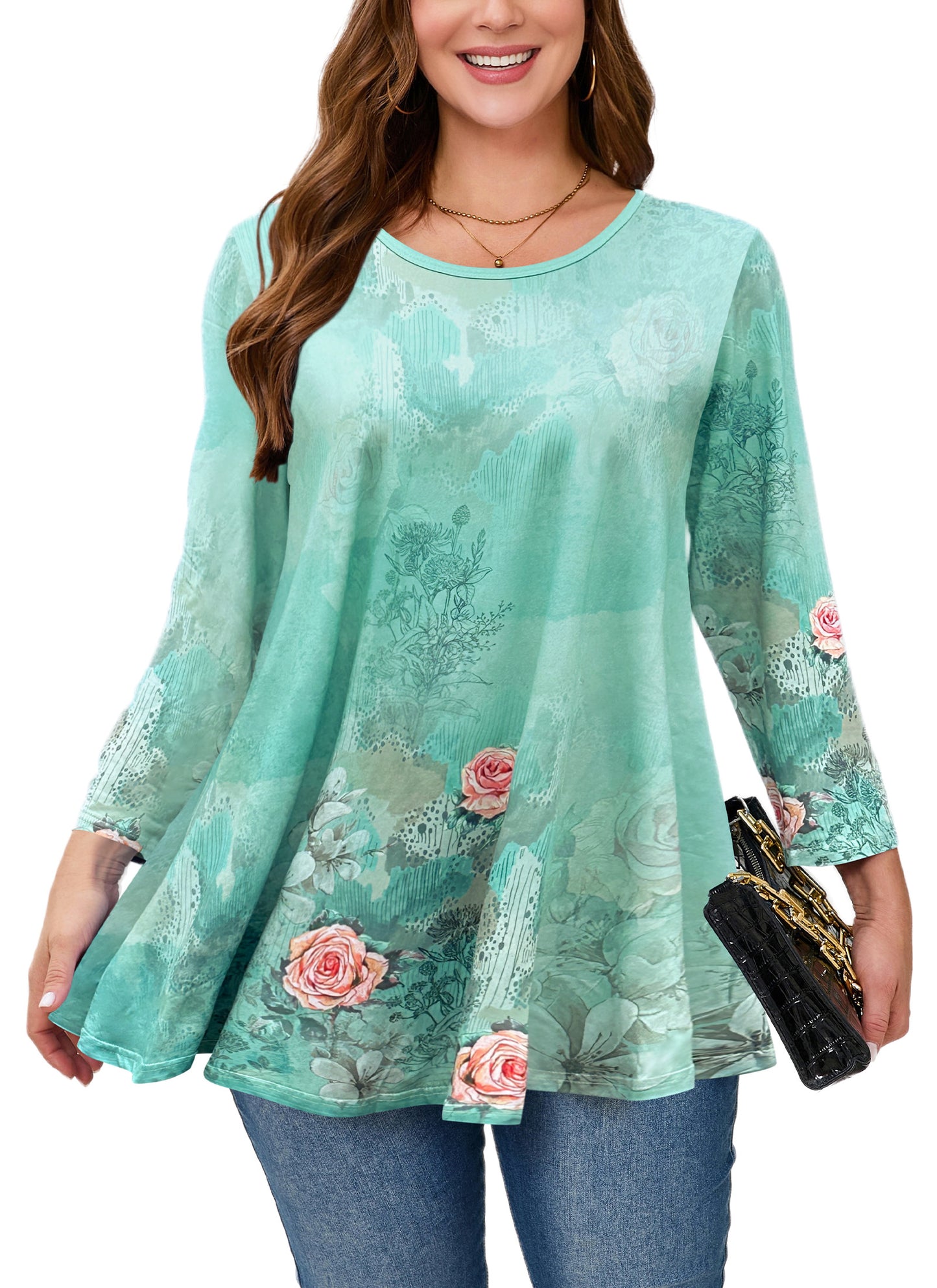 Woman wearing a teal lace top with floral embroidery on a white background